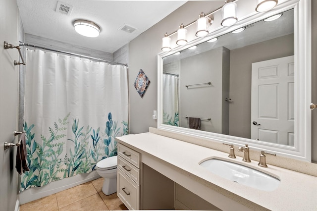 bathroom with tile patterned flooring, visible vents, toilet, and vanity