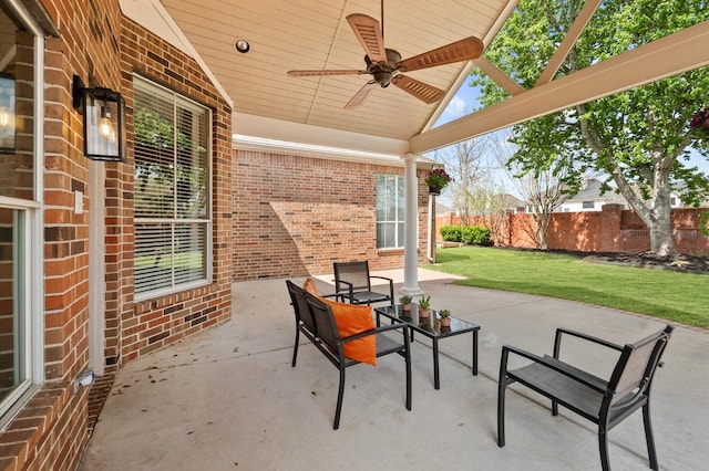 view of patio featuring a ceiling fan and fence