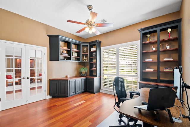 home office featuring visible vents, french doors, light wood-type flooring, and ceiling fan