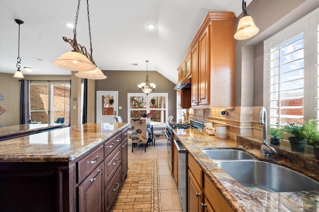 kitchen with a notable chandelier, a healthy amount of sunlight, backsplash, and a sink