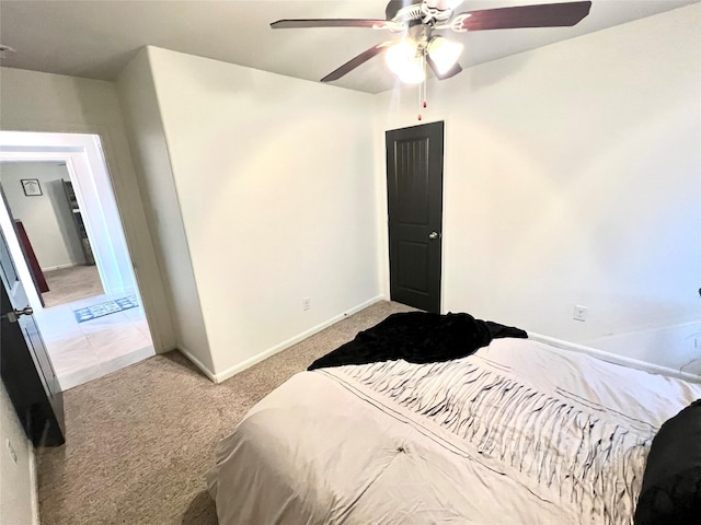 bedroom with baseboards, light colored carpet, and ceiling fan