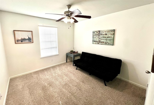 living area with light colored carpet, baseboards, and ceiling fan