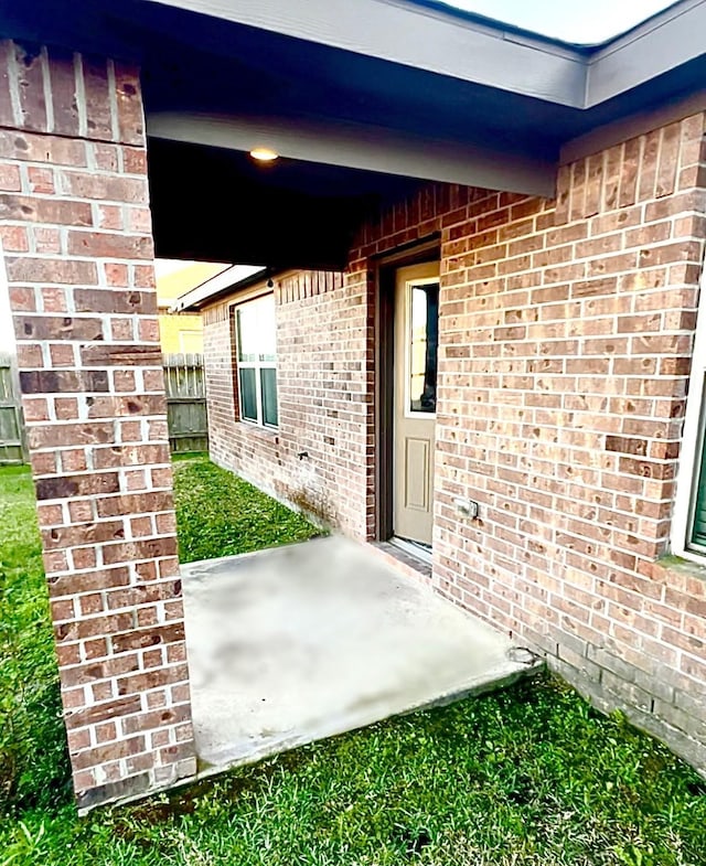 doorway to property with brick siding