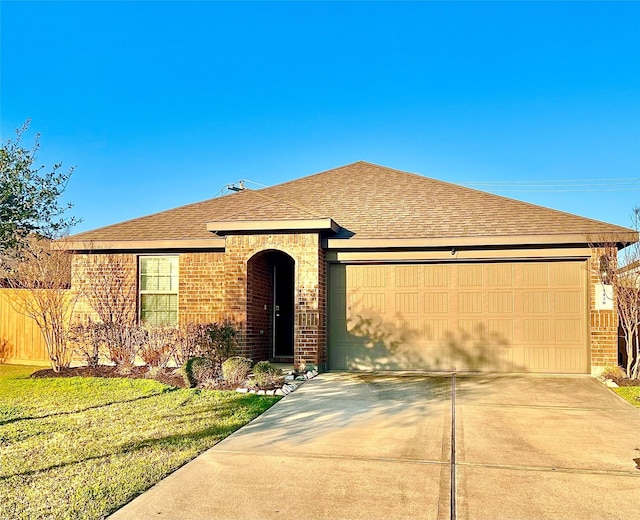 ranch-style house featuring a front lawn, driveway, a shingled roof, a garage, and brick siding