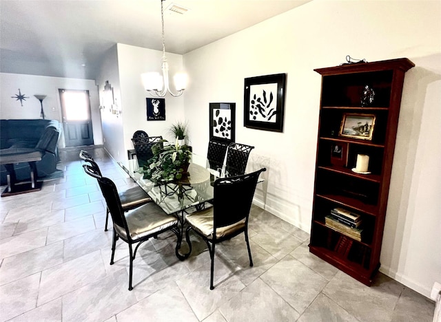 dining room featuring light tile patterned floors, visible vents, baseboards, and a chandelier