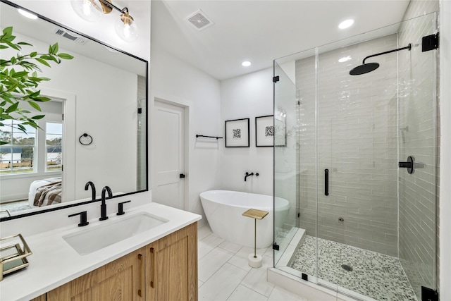 bathroom featuring visible vents, a shower stall, ensuite bathroom, a soaking tub, and vanity