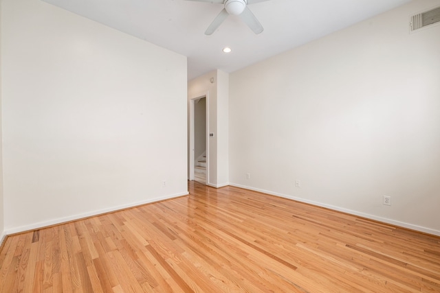 unfurnished room with a ceiling fan, visible vents, baseboards, recessed lighting, and light wood-style floors