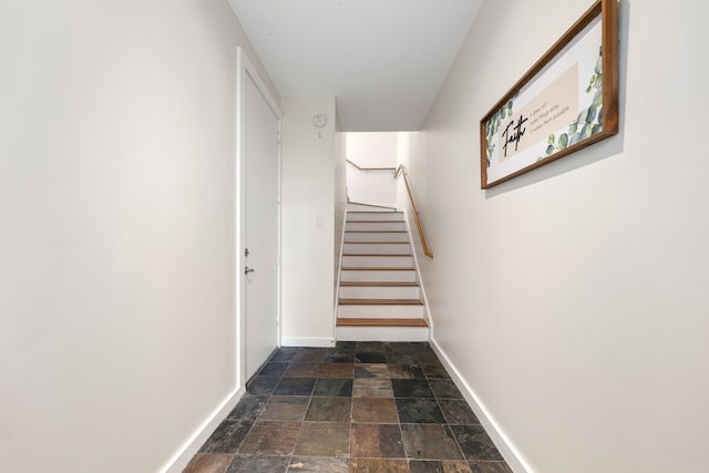 stairway with stone finish flooring and baseboards