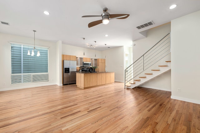 kitchen featuring open floor plan, visible vents, and stainless steel appliances