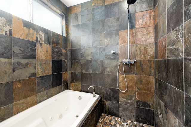 full bathroom with a jetted tub and tiled shower