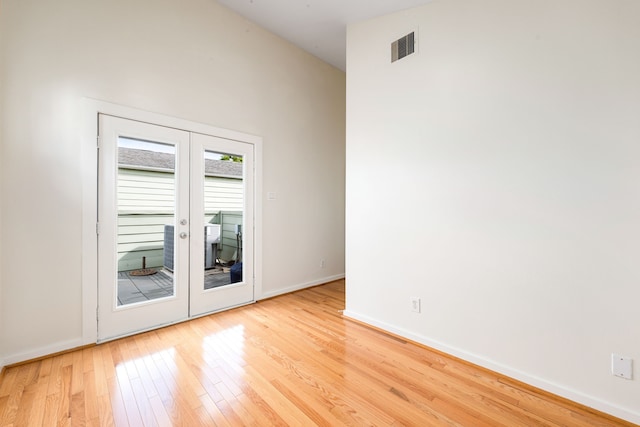 spare room featuring visible vents, french doors, light wood-type flooring, and baseboards