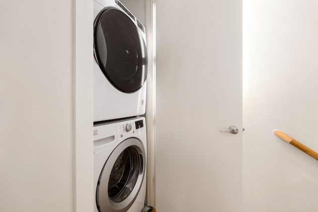 laundry area with stacked washer / dryer and laundry area