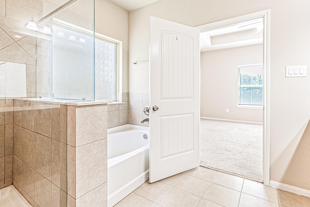 bathroom with a shower stall, a bath, and tile patterned floors