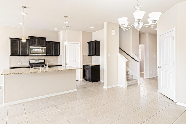 kitchen featuring a notable chandelier, backsplash, stainless steel appliances, light tile patterned flooring, and light stone countertops