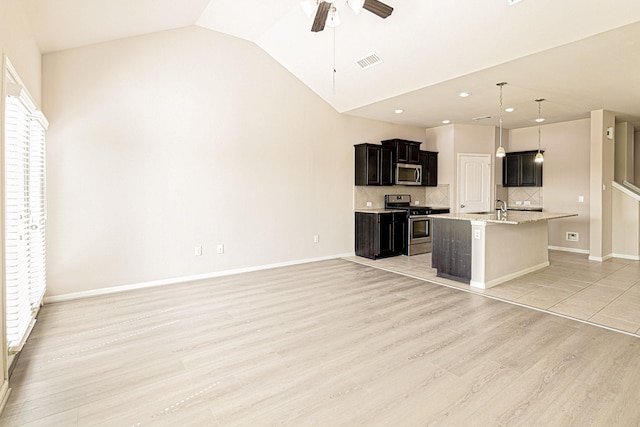 kitchen with visible vents, light wood-style flooring, ceiling fan, a sink, and stainless steel appliances