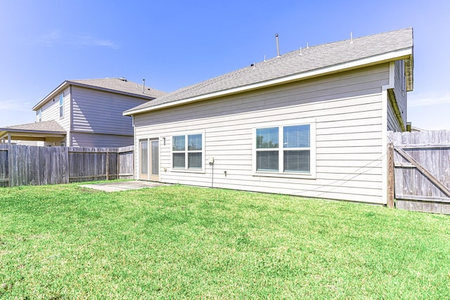 back of property featuring a fenced backyard and a yard