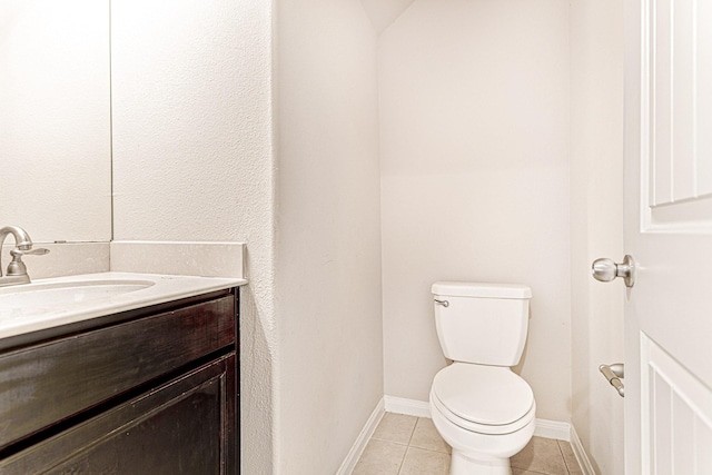 bathroom featuring tile patterned flooring, toilet, vanity, and baseboards