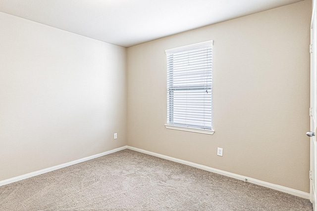 unfurnished room featuring baseboards and carpet floors