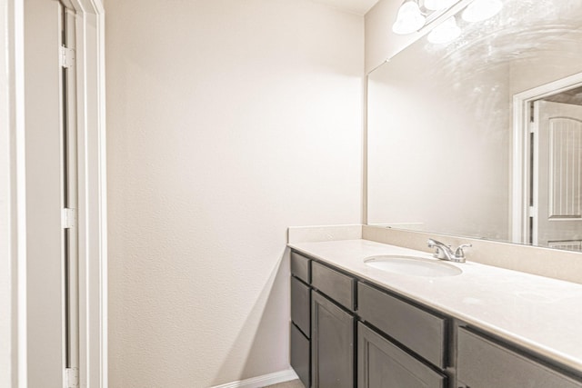 bathroom featuring baseboards and vanity