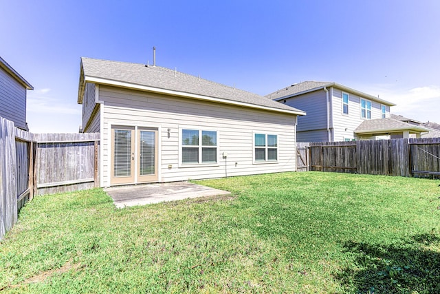 back of property featuring a lawn, a patio, and a fenced backyard