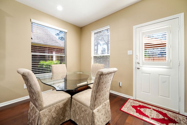 dining room with baseboards and dark wood-style flooring