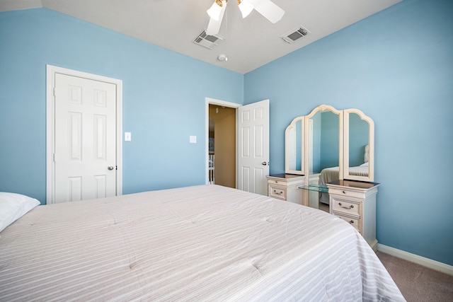 carpeted bedroom with visible vents, baseboards, and a ceiling fan