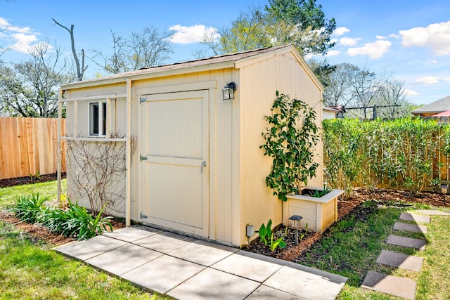 view of shed with a fenced backyard