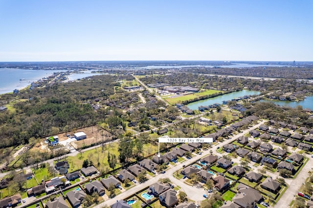 drone / aerial view with a residential view and a water view