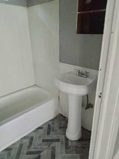 bathroom with a tub and a sink