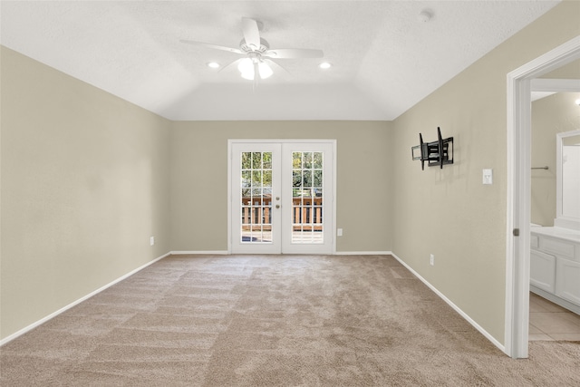 empty room with french doors, baseboards, lofted ceiling, light colored carpet, and ceiling fan