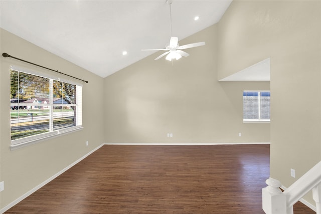 unfurnished room featuring baseboards, wood finished floors, high vaulted ceiling, and ceiling fan