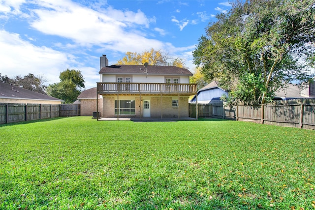 rear view of property with a lawn, cooling unit, a chimney, a fenced backyard, and a patio