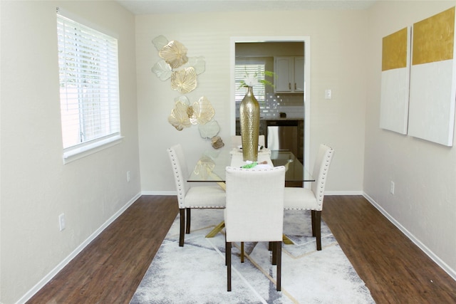 dining area with wood finished floors and baseboards