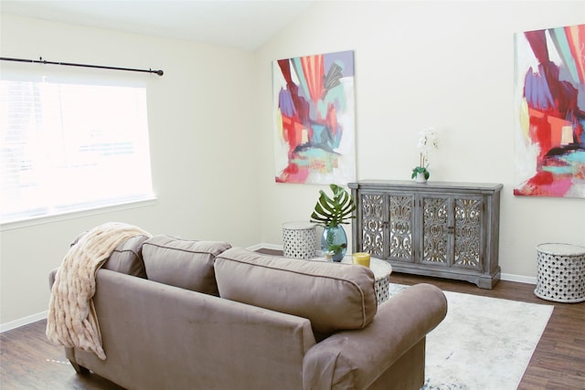 living room featuring baseboards, lofted ceiling, and wood finished floors