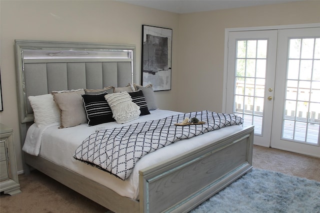 bedroom with french doors, multiple windows, carpet, and access to exterior