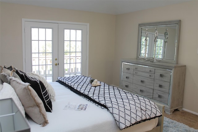 carpeted bedroom featuring french doors, baseboards, and access to outside