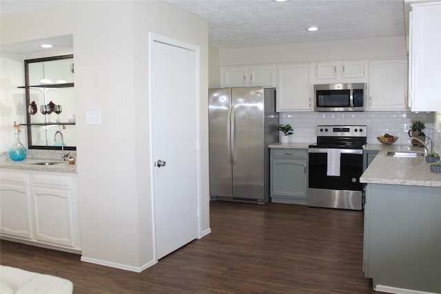 kitchen featuring white cabinets, appliances with stainless steel finishes, and a sink