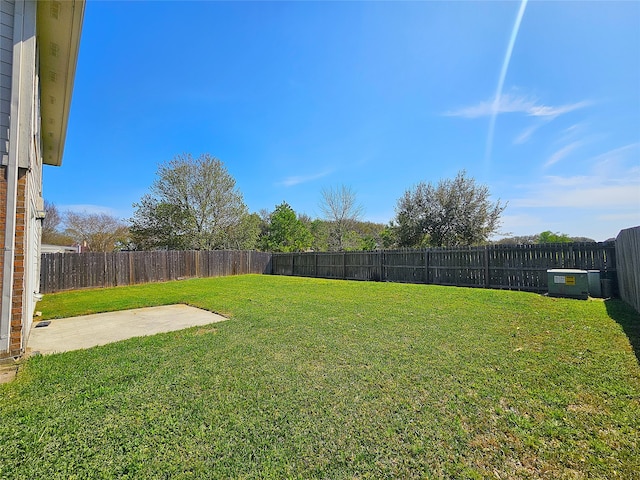 view of yard featuring a patio and a fenced backyard