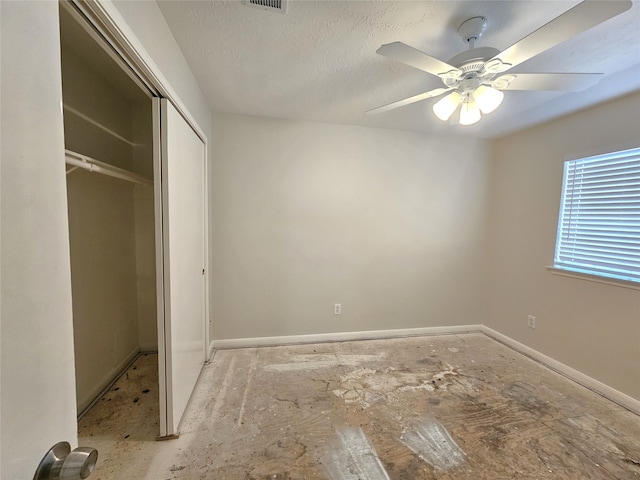 unfurnished bedroom with visible vents, ceiling fan, baseboards, a closet, and a textured ceiling