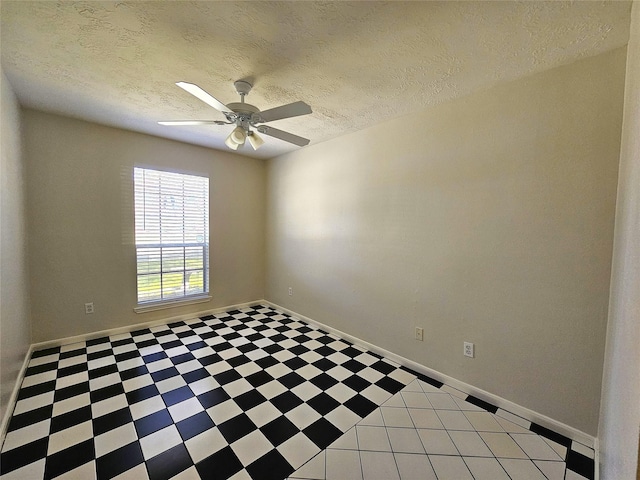 empty room with baseboards, a textured ceiling, and a ceiling fan