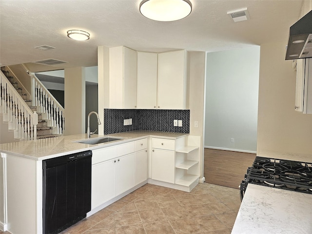 kitchen featuring range with gas stovetop, visible vents, a sink, light countertops, and black dishwasher