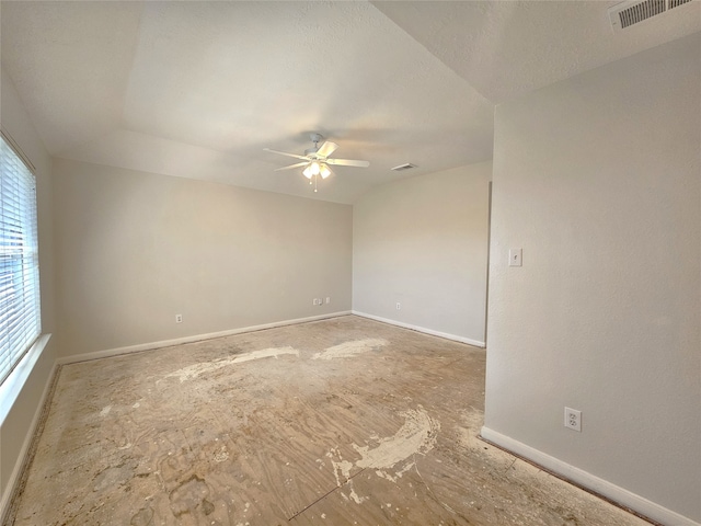 unfurnished room with a textured ceiling, baseboards, visible vents, and ceiling fan