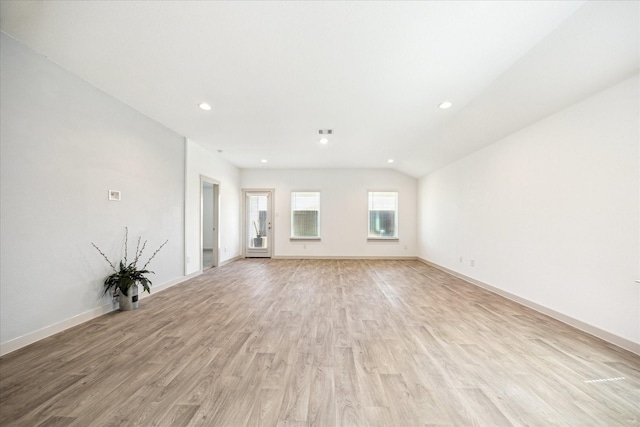 unfurnished living room with visible vents, baseboards, recessed lighting, vaulted ceiling, and light wood-style floors