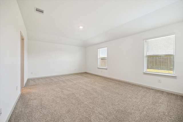 spare room featuring recessed lighting, baseboards, visible vents, and light carpet