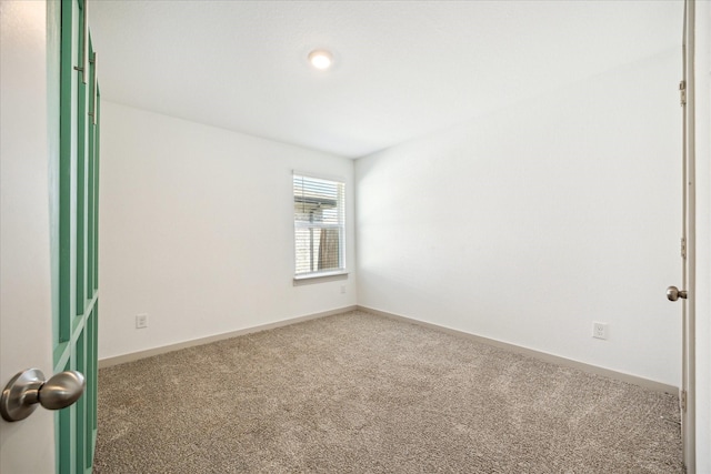 carpeted empty room with baseboards