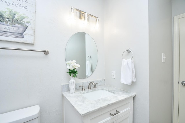 half bathroom with toilet and vanity