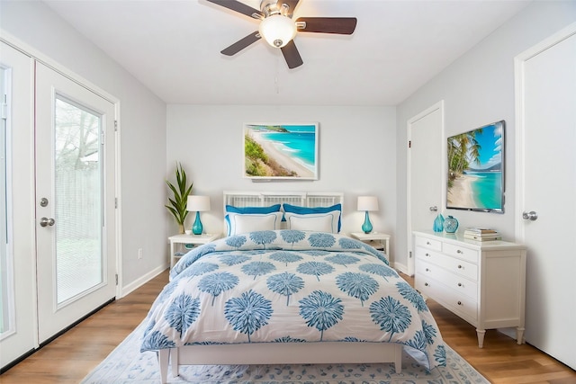 bedroom featuring access to exterior, a ceiling fan, light wood-type flooring, and baseboards