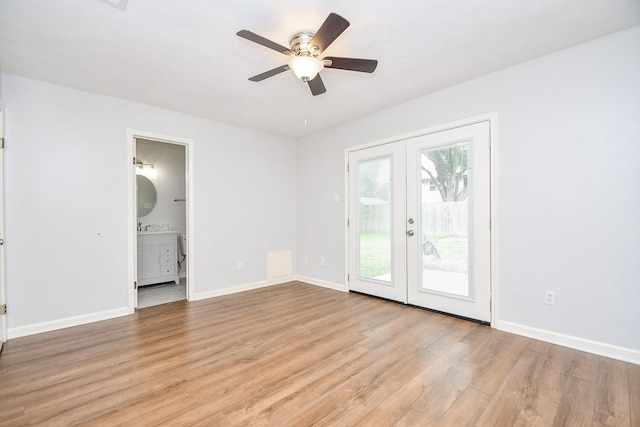 empty room featuring french doors, baseboards, light wood-type flooring, and ceiling fan