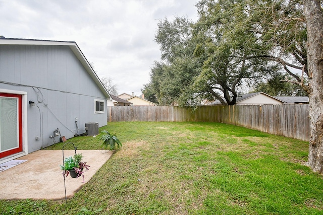 view of yard featuring a fenced backyard, a patio, and central AC