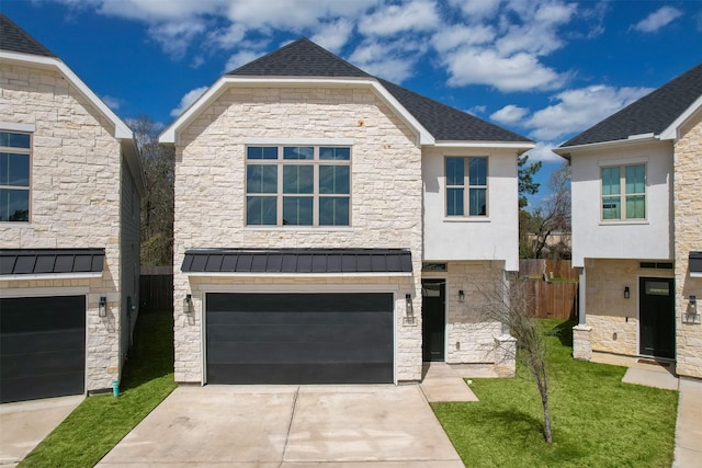 view of front of property featuring driveway, a standing seam roof, stone siding, an attached garage, and metal roof